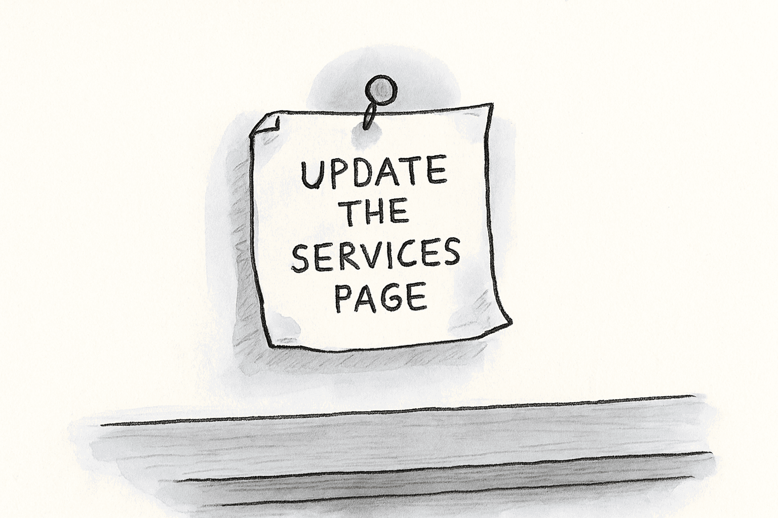 A folded paper note labeled 'update the services page' pinned to a wall above a desk, with curled corners and a faint dust line on the desk.